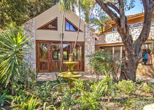 a house with a swing in the yard at Sunward Park Guest House & Conference Center in Boksburg