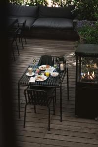 a table with food on it on a patio at Avenue Hotel Copenhagen by Brøchner Hotels in Copenhagen