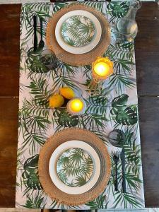 a table with two plates and oranges on a table at Casa de Pera in Mytilini
