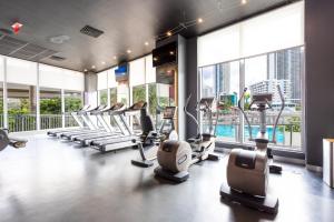 a gym with treadmills and ellipticals in a building at Modern two bed Beach Walk Miami 15th in Hollywood