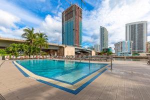 a swimming pool in a city with tall buildings at Modern two bed Beach Walk Miami 15th in Hollywood