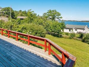 a red bench sitting on top of a wooden deck at 6 person holiday home in Sandefjord-By Traum in Sandefjord +28 photos
