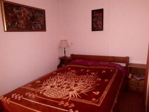 a bedroom with a bed with a red comforter at Traditional house in Kalívia
