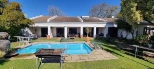 a swimming pool in the backyard of a house at B My Guest in Knysna