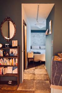 a bedroom with a bed and a mirror and a book shelf at TOE LIBRARY Tokyo Asakusa in Tokyo