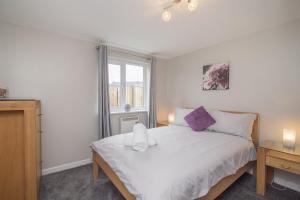 a bedroom with a white bed and a window at The Nelson - Spacious City Property and Free Parking in Glasgow