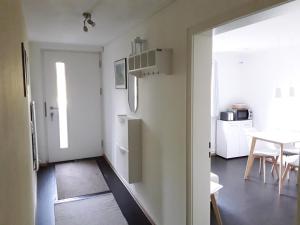 a kitchen with a white refrigerator and a table at Apartment am Gifizsee Offenburg in Offenburg