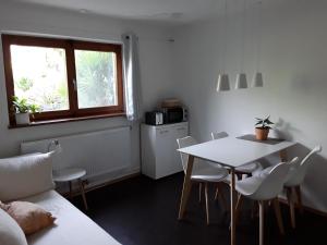 a kitchen with a table and a table and chairs at Apartment am Gifizsee Offenburg in Offenburg