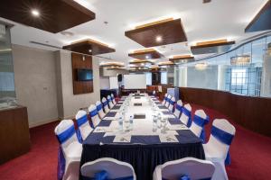 a conference room with a long table and chairs at City Premiere Hotel Apartments - Dubai in Dubai