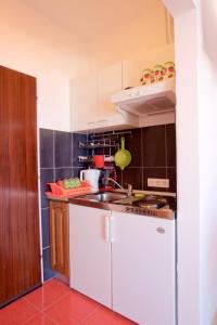 a kitchen with a sink and a counter top at Apartments by the sea Brist, Makarska - 13011 in Podaca