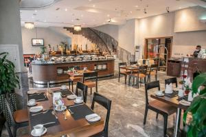 a restaurant with tables and chairs and a counter at City Premiere Hotel Apartments - Dubai in Dubai