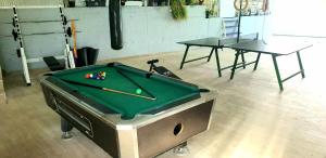 a pool table in a room with a table and a pool cue at Villa Anja Lux, Split in Split