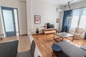 a living room with a couch and a table at Hamaretou Apartment in Sparta