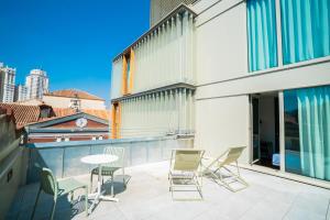 een patio met stoelen en een tafel op een balkon bij Akeah Hotel Gran Vía in Madrid