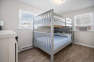 a white bunk bed in a white room at Relax and enjoy the Beach Beautifully updated in Brigantine