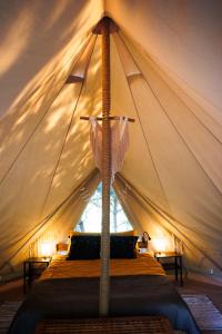 a bedroom in a tent with a bed in it at Glamping - Projekt Alpaka in Garbatka-Letnisko