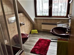 a bathroom with a sink and a toilet at Gästehaus Ainser in Hagnau