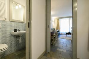 a bathroom with a toilet and a sink at Alpesmith - Bike & Ski apartments in Bardonecchia +62 photos