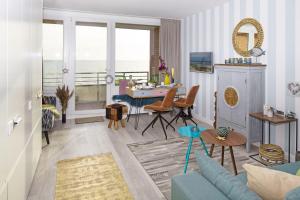 a living room with a blue couch and a table at Lieblingsblick in List +12 photos