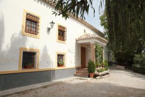 una casa bianca con finestre e una porta di El Molino de Batán a Galera