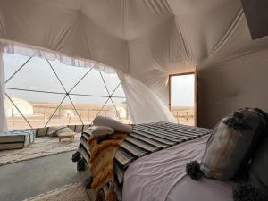 a bedroom with a bed with a view of the desert at agafay valley in Marrakech