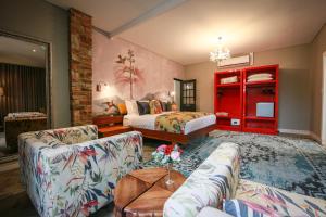 ein Wohnzimmer mit einem Bett und einem Sofa in der Unterkunft Droombos in Windhoek