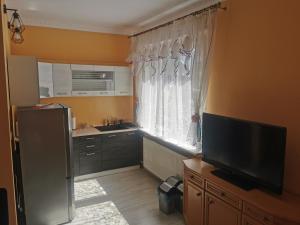 a kitchen with a large window and a television at Przystań Familijna in Santoczno +24 photos
