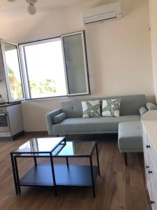 a living room with a couch and a table at Le maioliche allo Stagnone kite in Marsala