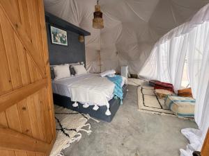 a bedroom with a bed in a tent at agafay valley in Marrakech