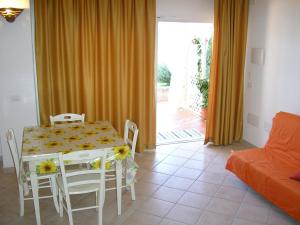 a living room with a table and chairs and a couch at Appartamenti Il Giardino in Porto Rotondo +32 photos