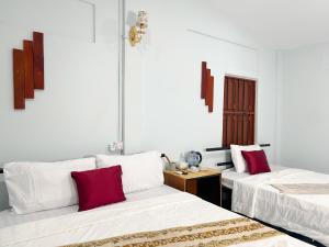 Postel nebo postele na pokoji v ubytování Lotus Blanc Homestay