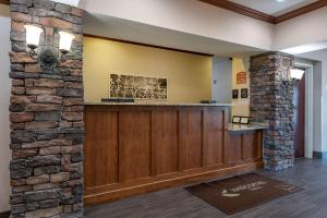 a bar in a lobby with a stone wall at Sleep Inn & Suites Oakley I-70 in Oakley