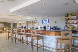 a bar in a restaurant with a row of chairs at San Lameer Villa 2015 - 3 Bedroom Standard - 6 pax - San Lameer Rental Agency in Southbroom