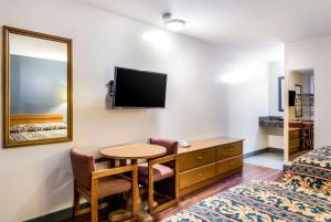 a hotel room with a table and a mirror at Rodeway Inn North Chesterfield-Richmond in Richmond