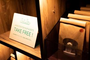 a sign that says take free on a shelf at Prince Smart Inn Kyoto Sanjo in Kyoto