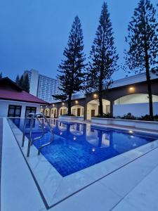 a swimming pool with blue water at night at Tagaytay Country Hotel in Tagaytay