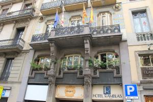 
a building with a large window and a clock on the side of it at Ramblas Hotel in Barcelona
