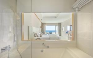 a bathroom with a bed and a shower and a mirror at Royal Azur Thalassa in Hammamet