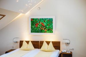 a bedroom with a bed and a painting on the wall at ODELYA - Stadthotel im Park in Basel