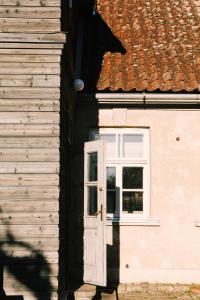 a house with a white door and a window at Kalnciema kvartāla Kuldīgas rezidence in Kuldīga