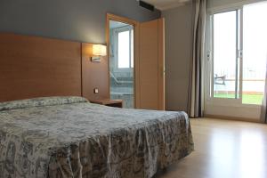 Posteľ alebo postele v izbe v ubytovaní Ramblas Hotel