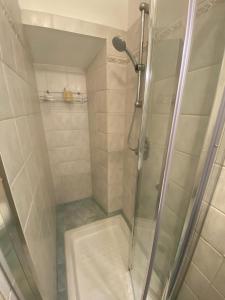a shower with a glass door in a bathroom at Meraviglia in Vetralla
