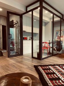 a living room with sliding glass doors and a table at Kazbegi Stylish Apartment in Kazbegi