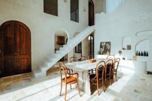 a dining room with a table and chairs and a staircase at Casa Viamo in Canggu