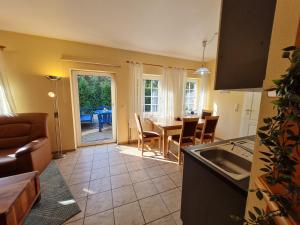 a kitchen and living room with a table and chairs at Pension & Ferienhof Glüß in Lünzen