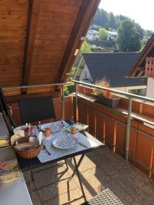 a picnic table on the balcony of a house at Ferienwohnung Herbert Best in Baiersbronn