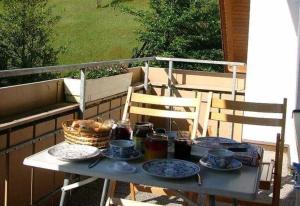 una mesa con platos de comida en el balcón en Ferienwohnung Herbert Best en Baiersbronn
