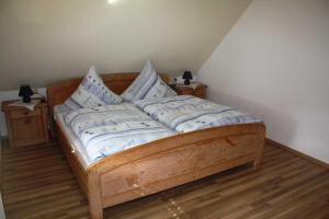 a wooden bed with pillows on it in a room at Ferienwohnung Herbert Best in Baiersbronn