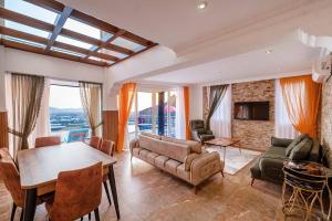 a living room with a couch and a table at Sessiz,Sakin, huzurlu jakuzi ve saunalı deniz,doğa manzaralı müstakil villa in Fethiye