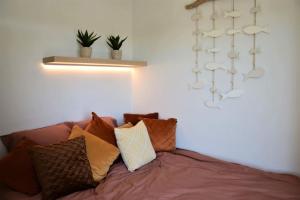 a couch with a bunch of pillows on it at HHVDK aan zee in Oostduinkerke